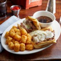 French Dip Sandwich · Shaved roast beef and provolone cheese served hot on a toasted hoagie roll with a side of au...