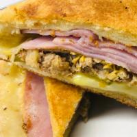 Traditional Cuban Sandwich  · Pulled Pork, Sliced Ham, Gooey Swiss Cheese, Pickles And Mustard with Your Choice Of Two Sid...