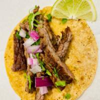 Grilled Steak Taco · Cilantro, onion, and lime.