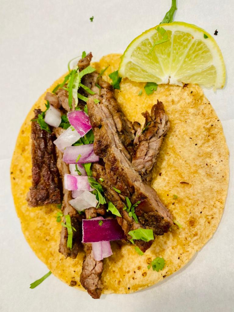 Grilled Steak Taco · Cilantro, onion, and lime.