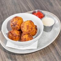 Hash Holes · 6 hash brown croquettes made with cheddar, smoked gouda and bacon. Served with Southwest Ran...