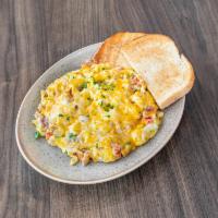 Denver Scramble · Ham, green and red peppers, onions with scrambled eggs and cheddar cheese, served with hash ...