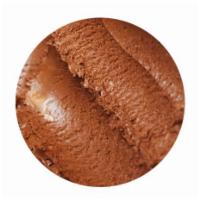 Muddy Buddy Ice Cream · Milk chocolate ice cream with swirls of peanut butter and pieces of homemade chex.