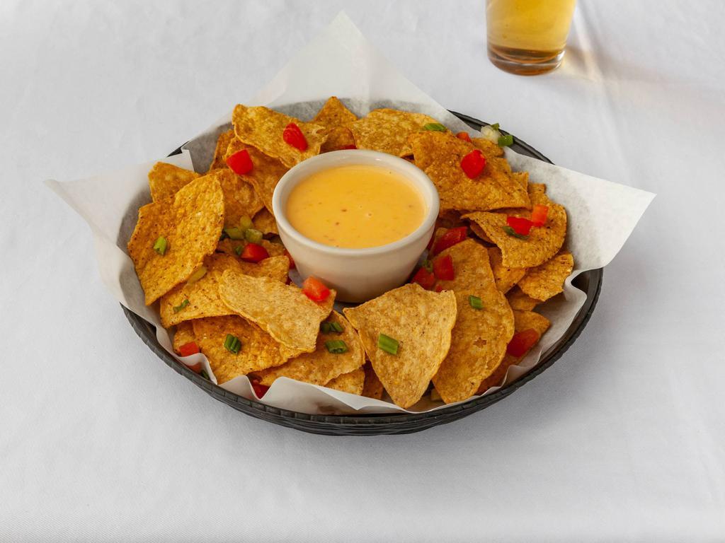 Chips and Cheese · Homemade tortilla chips with queso dipping sauce. 