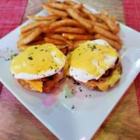 Eggs Benedict · Ham or bacon, 2 poached eggs on English muffin topped with creamy hollandaise sauce with fri...
