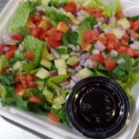 Israel House Salad · Chopped lettuce, cucumbers, tomatoes, and red onions with red wibe olive oil on the side.