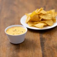 Chile con Queso Dip · Mild melted cheese with diced tomatoes, peppers and served in bowl for dipping.