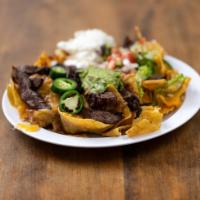 Nachos al Pastor · Crispy corn tortilla chips covered with refried beans, melted cheese strips of grilled pork,...
