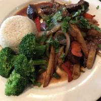 Lomo Saltado · Grilled strips of steak with tomatoes, onions, green peppers, celery, jalapeno, cilantro and...