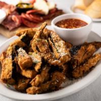 Eggplant Fries · Freshly breaded eggplant served with a side of house sauce.