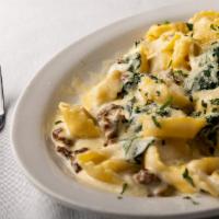 Tortellini di Marco · Cheese tortellini with sauteed spinach, ground Italian sausage in a light garlic creme sauce.