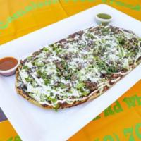 Huarache · Each. Handmade thick tortilla with the meat of your choice. Topped with onion, cilantro, cre...