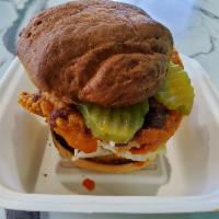 Nashville Hot · Crispy chicken coated with Nashville hot sauce on a toasted bun and topped with slaw and pic...