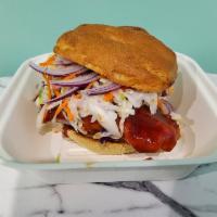 BBQ Chicken Sandwich · Crispy chicken tossed in BBQ sauce placed on a toasted bun with slaw, cheddar cheese and pic...