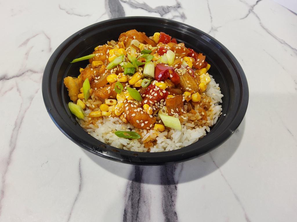 Dragon Chicken Rice Bowl · Crispy chicken, peppers, onions, shredded carrots and mini baby corn tossed in Dragon sauce.  Garnished with cilantro, green onions and sesame seeds.