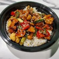 Teriyaki Chicken Rice Bowl · Crispy chicken, peppers, green onions, and mushrooms tossed in teriyaki sauce.  Garnished wi...