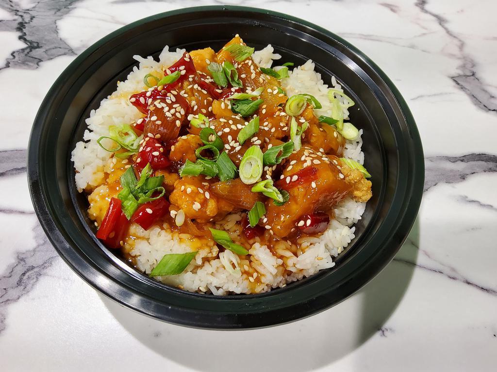 Sweet & Sour Chicken Rice Bowl · Peppers, onions and pineapple tossed in sweet and sour sauce.  Garnished with green onions and sesame seeds.