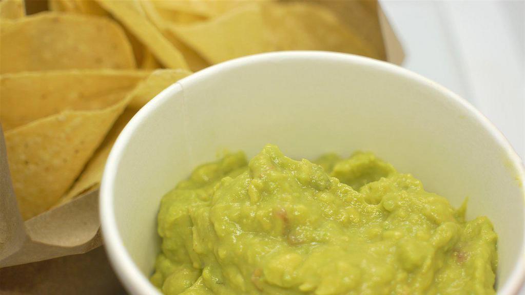 Chips & Guacamole · Corn tortillas and a large side of guacamole.