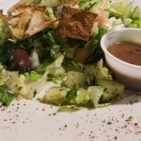 Fettouch Salad · Romaine lettuce, tomatoes, cucumber and pita chips with balsamic vinaigrette.