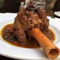 Spicy Lamb Tagine · Slow cooked lamb shank in jalapenos sauce topped with roasted almonds and drizzled with sesa...
