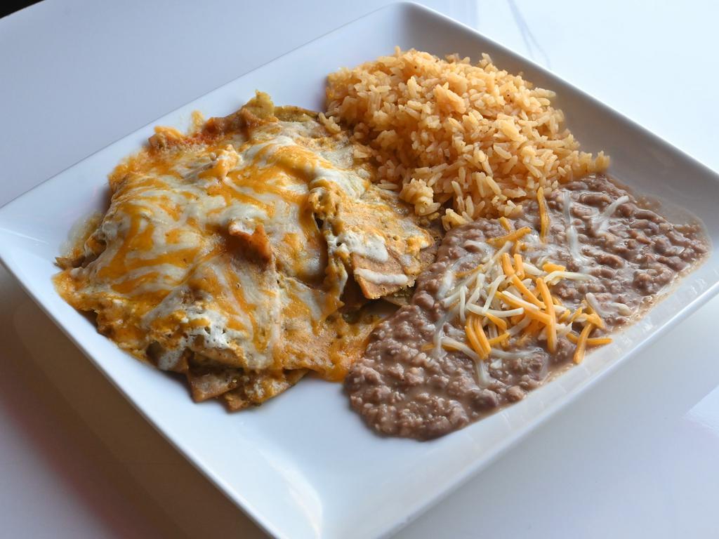 Mexican Chilaquiles · Fried tortilla chips w/ our ranchero sauce topped w. melted cheese, served with rice and beans