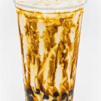 Tiger Milk with Boba · Fresh boba pearls in brown simple syrup drizzled with caramel, served with cold frothy milk....