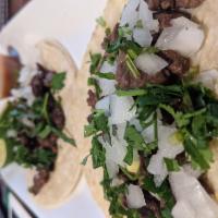 Steak Taco  · Served in a corn tortilla with lime-cilantro, onions, and a homemade hot sauce.