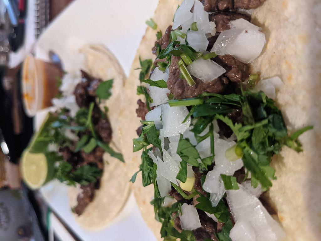 Steak Taco  · Served in a corn tortilla with lime-cilantro, onions, and a homemade hot sauce.