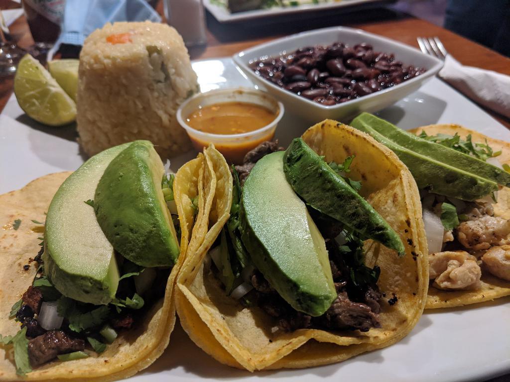 Taco Combination  · A combination of three tacos, chicken, seasoned steak, and marinated pork. Topped with cilantro and chopped onions and avocados served with rice, beans, and a homemade la hacienda hot sauce.
