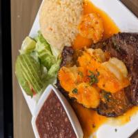 Surf N Turf · This juicy combination comes with our famous Carne Elsada, topped with pan scared shrimp bat...