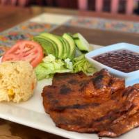 Carne Adobada · Pork marinated in chile guajillo sauce. Served with rice, beans, and a house salad.