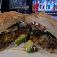 Steak Torta · A traditional Mexican sandwich made with fresh bread, lettuce, avocado, beans, mayonnaise, j...