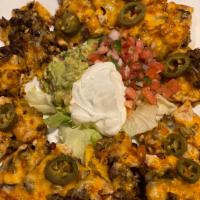 Steak Nacho · Served with melted cheese, beans, jalapenos, and a side of guacamole, sour cream, and pico d...