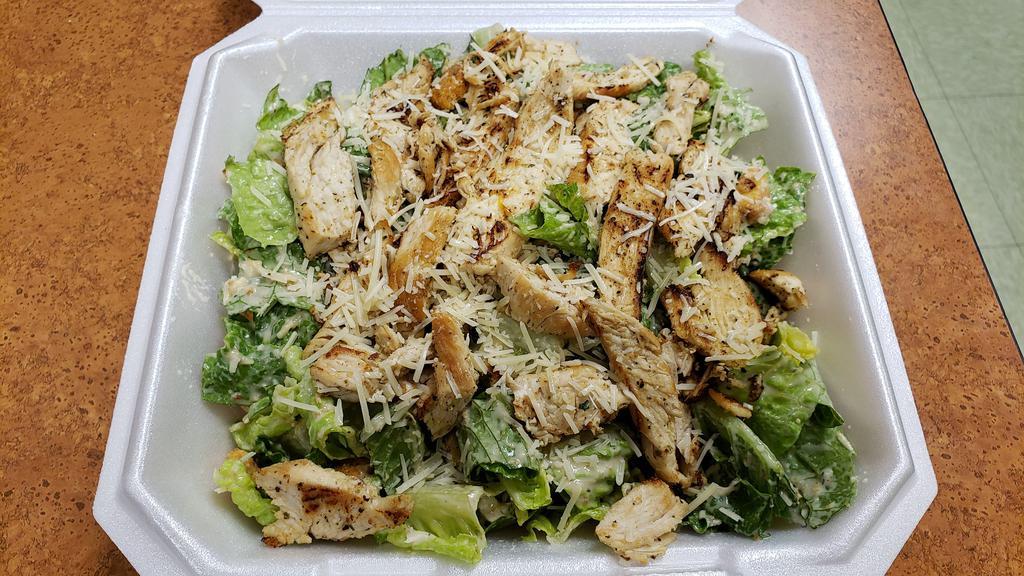 Chicken Caesar Salad · Romaine lettuce with chicken, Parmesan, croutons and Caesar dressing on the side.