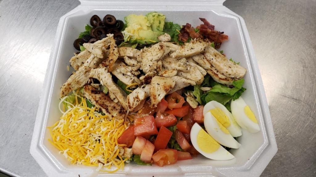 Cobb Salad · Romaine lettuce, chicken, bacon, avocado, egg, cheese, tomato, and olives.