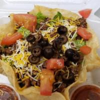 Taco Salad · Romaine lettuce, tortilla shell with choice of chicken or taco meat, cheese, tomato, olives,...