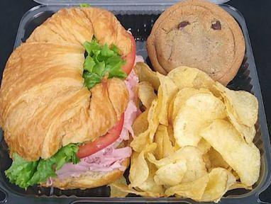 Croissant Box Lunch · Individually boxed Croissant Sandwich, Kettle Chips, and Cookie. Sandwich made with lettuce, tomato, and packets of mayo/mustard. Consider adding a bottled drink.