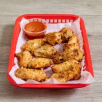 Wings  · Cooked wing of a chicken coated in sauce or seasoning.
