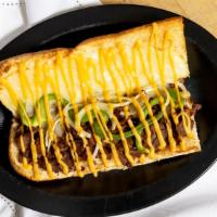 Cheesesteak Grinder · Mozzarella-provolone cheese, Garlic Butter, Steak, Onion, Green Pepper & Topped with Cheese ...