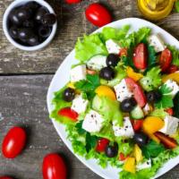 Greek Salad · Tomatoes, cucumbers, bell pepper, onion, feta cheese, and olives and dressed with salt, pepp...