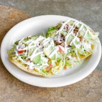 Tostadas · 2 fried corn tortillas topped with fried beans, lettuce, onions, tomatoes, cream, and cheese...