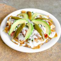 Nachos · Roasted tortillas with choice of meat or regular with no meat. Topped with cream, beans, cil...