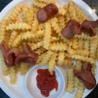 Salchipapas · French fries with sausage.