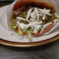 Gordita · A delicious corn cake stuffed with Mexican pulled pork, sour cream, feta cheese lettuce and ...