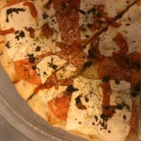 Crispino Pizza · Delicious Fresh mozzarella, roasted red peppers, fresh tomatoes and basil. Drizzled with bls...