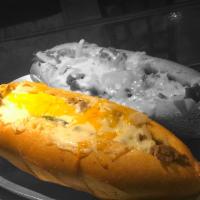 Philly Cheese Steak Hero · Premium steak fillet sautéed with onions and peppers topped with melted mozzarella and chedd...