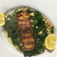 Grilled Salmon · Grilled salmon over a bed of sauteed spinach and cannellini beans, extra virgin olive oil.
