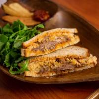 Reuben Sandwich · Beef pastrami, sauerkraut, russian dressing, and swiss cheese on rye bread.
