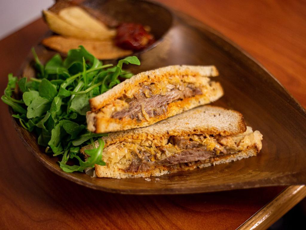 Reuben Sandwich · Beef pastrami, sauerkraut, russian dressing, and swiss cheese on rye bread.
