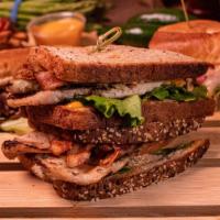 Grill Chicken Sandwich · Lettuce, tomato, bacon, avocado, and chipotle aioli on multi-grain bread.